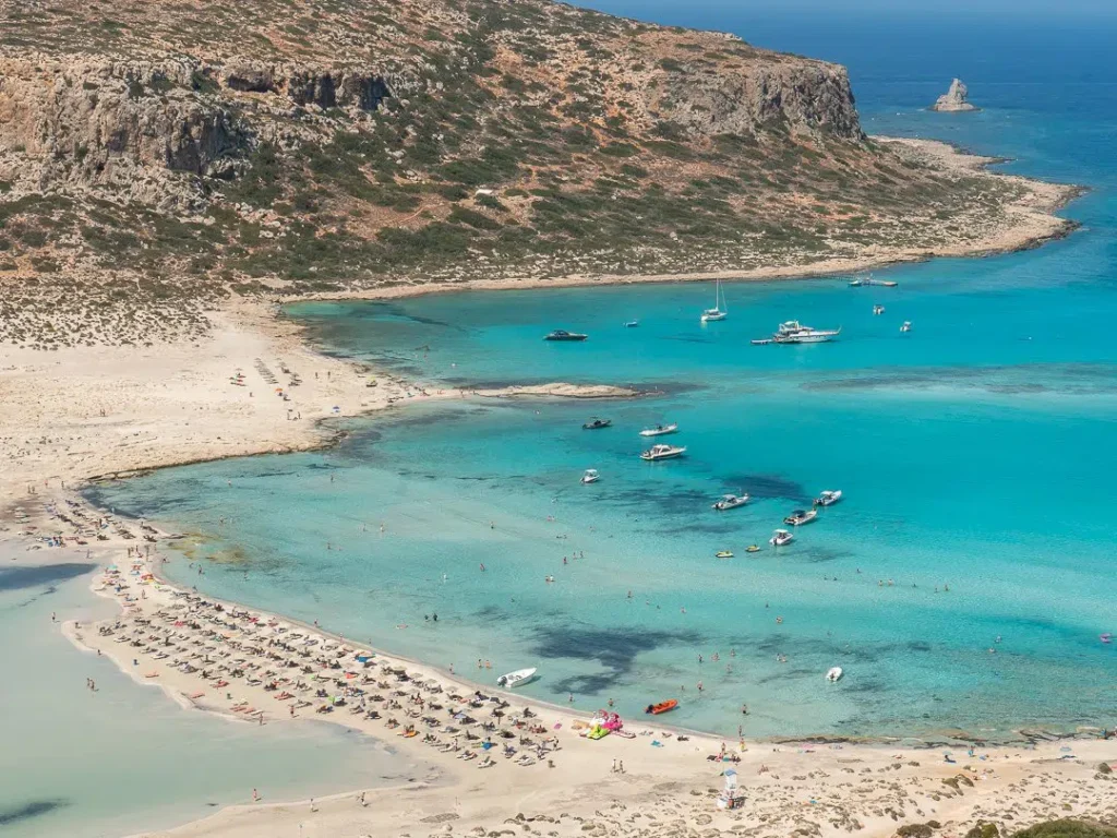 Best Sandy Beaches in Crete - 2. Balos Lagoon Crete, an island renowned for its natural beauty and breathtaking landscapes, is home to some of the most mesmerizing beaches in the Mediterranean. Among these, 10 Best Beaches in Crete is a list that undoubtedly includes Balos Lagoon. Known for its unique mix of turquoise waters, white sand, and spectacular surrounding scenery, Balos Lagoon is often regarded as one of the most stunning beaches not just in Crete, but in the entire world. Located on the northwestern coast of the island, this lagoon has captured the hearts of travelers seeking an unparalleled beach experience.