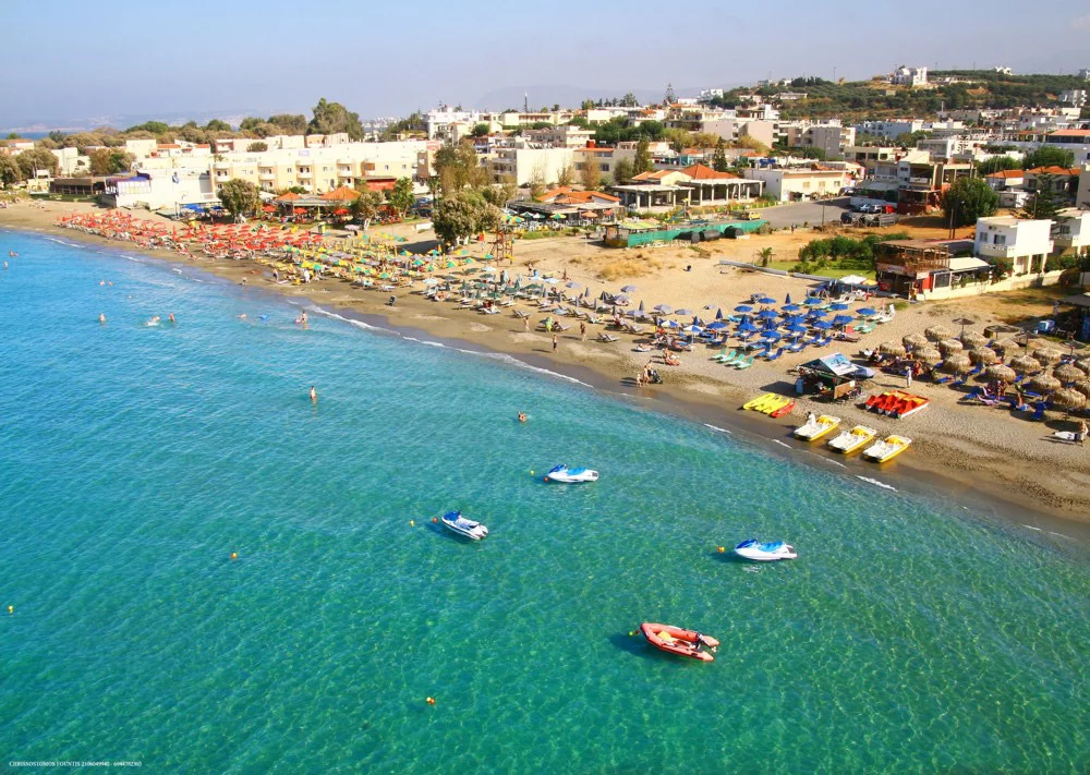 Best Sandy Beaches in Crete - 9. Agia Marina Beach, ## **Agia Marina Beach: A Popular Beach Destination in Crete**

**Agia Marina Beach**, located on the **northwest coast of Crete**, is one of the island's most beloved beaches, attracting both locals and tourists alike. Just a short distance from the city of **Chania**, Agia Marina offers the perfect combination of natural beauty, modern amenities, and a lively atmosphere. With its clear turquoise waters, golden sand, and excellent facilities, Agia Marina is ideal for families, couples, and anyone looking to enjoy a relaxing day by the sea.

### **Why Agia Marina Beach is Famous**

Agia Marina Beach is famous for its beautiful setting and family-friendly environment. The beach is easily accessible and stretches for several kilometers along the coast, offering plenty of space for visitors to enjoy sunbathing, swimming, and various water activities. The beach is well-known for its fine sand and shallow waters, which are perfect for children and people who prefer calmer seas. 

The area around the beach is also home to many **restaurants**, **cafes**, and **shops**, making it a convenient place to spend a whole day, with the option to grab a bite to eat or shop for souvenirs. The nearby **Agia Marina village** has a charming, traditional atmosphere, while the beach itself has a lively, cosmopolitan vibe, especially during the summer months.

### **The Best Activities at Agia Marina Beach**

1. **Swimming and Sunbathing**: The calm, shallow waters of Agia Marina Beach make it a great spot for swimming, especially for families with children. The beach is known for its clean, clear waters and fine golden sand, perfect for relaxing under the sun. Whether you prefer to sunbathe on the beach or take a swim in the sea, Agia Marina offers the ideal environment for both.

2. **Water Sports**: Agia Marina Beach is a popular location for water sports, such as **jet skiing**, **windsurfing**, and **parasailing**. There are several rental shops along the beach where you can hire equipment for these activities. The gentle waves and warm waters provide perfect conditions for both beginners and more experienced water sports enthusiasts.

3. **Snorkeling and Diving**: For those interested in exploring the underwater world, **snorkeling** and **scuba diving** are great activities at Agia Marina Beach. The clear waters around the beach allow for excellent visibility, and the rocky seabed nearby offers interesting spots to discover marine life. There are diving centers in the area where you can arrange guided tours and dive trips.

4. **Strolls and Sunset Views**: One of the most relaxing activities on Agia Marina Beach is simply taking a leisurely stroll along the shore. The long stretch of sand provides plenty of space to walk, and you can enjoy spectacular views of the **Cretan Sea** and the nearby **White Mountains**. The sunset views from Agia Marina are truly magical, making it an excellent spot for a romantic evening walk.

5. **Visiting the Agia Marina Village**: The nearby village of Agia Marina offers a taste of Cretan life with its quaint streets, local shops, and traditional tavernas. You can visit the village to experience authentic Cretan food and buy handmade crafts or souvenirs. The village is also home to several historical sites and landmarks, adding cultural interest to your visit.

### **How to Get to Agia Marina Beach**

1. **From Chania**: Agia Marina Beach is located just **9 kilometers west of Chania**, and it is easily accessible by car. The drive takes around **15-20 minutes**, depending on traffic. To get there, take the **E65 road** west from Chania, following the signs for Agia Marina.

2. **Public Transport**: Buses run frequently from **Chania** to **Agia Marina**, making it an easy destination to reach by public transport. The bus ride takes around 20 minutes, and once you arrive, the beach is within walking distance.

3. **Parking**: There are several parking areas near Agia Marina Beach, but it can get busy during the high season. Arriving early or later in the day can help secure a parking spot, especially during peak summer months.

### **Best Time to Visit Agia Marina Beach**

The best time to visit **Agia Marina Beach** is during the **spring (April to June)** and **early autumn (September to October)** when the weather is warm but the crowds are fewer. The summer months (July and August) attract a lot of tourists, especially during the peak vacation season, so it’s recommended to visit early in the morning or later in the evening to avoid the busiest times.

### **Conclusion**

**Agia Marina Beach** is one of Crete’s most popular and beautiful beach destinations, offering a perfect blend of natural beauty, excellent facilities, and plenty of activities for all types of visitors. Whether you’re looking to relax on the sandy shores, enjoy water sports, or explore the nearby village, Agia Marina provides an unforgettable beach experience. Its convenient location near Chania makes it easily accessible, while its friendly atmosphere and stunning surroundings ensure that it remains one of Crete’s top beach spots.